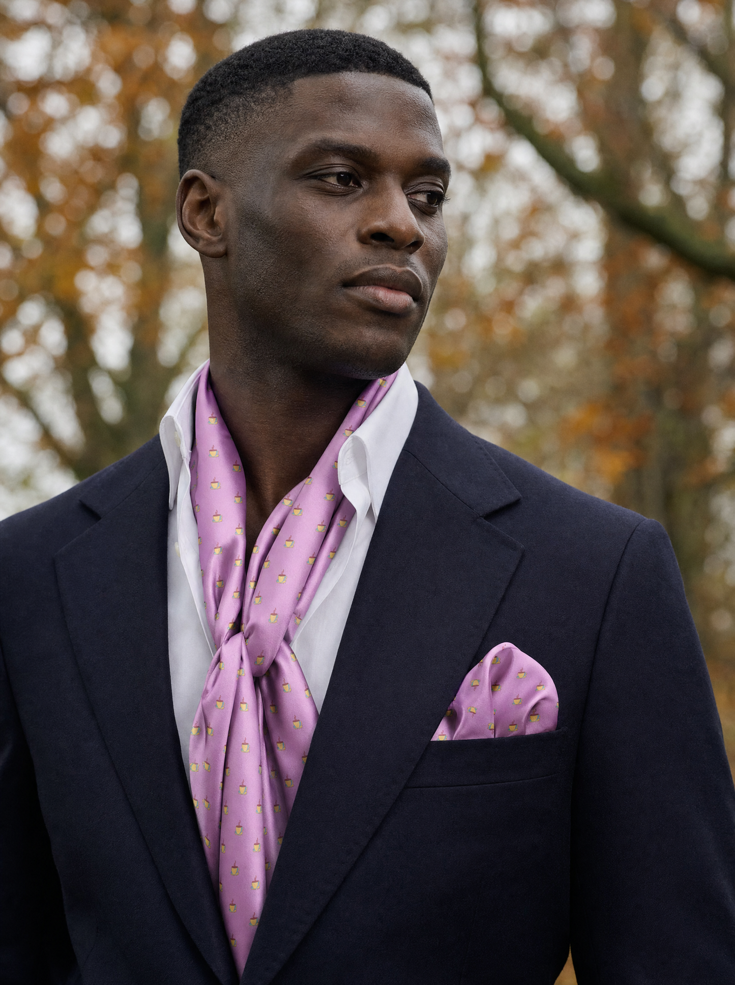 The Pink Tea Party Silk Scarf & Pocket Square Set worn by a model — men's scarf